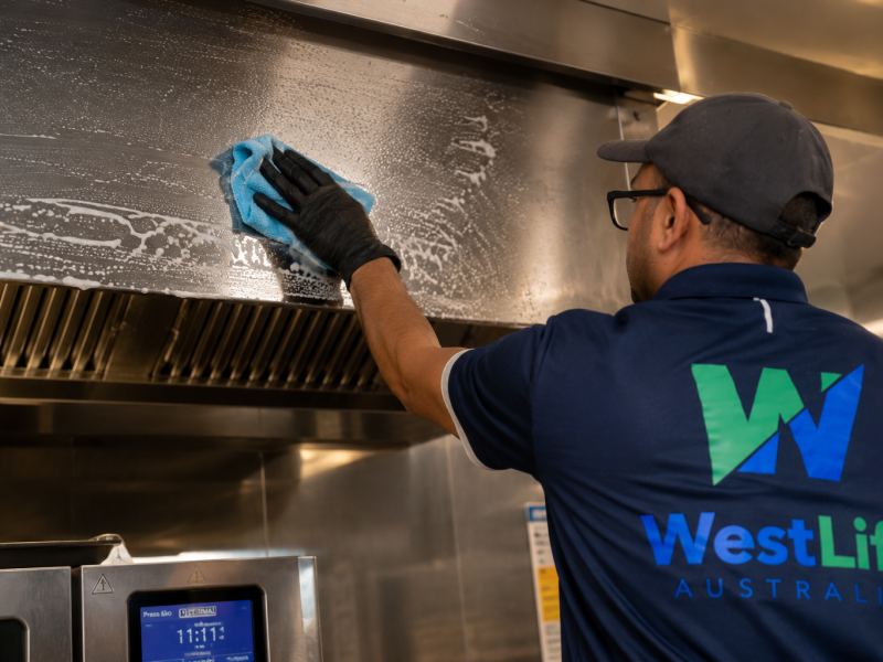 Commercial kitchen equipment being cleaned to remove grease and food residue.
